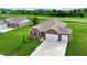 Beautiful aerial view of brick home with a two-car garage backing onto the golf course at 217 Saint Andrews Ave, Edinburgh, IN 46124
