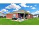 Expansive backyard featuring a covered patio and green lawn, perfect for outdoor activities at 217 Saint Andrews Ave, Edinburgh, IN 46124