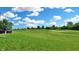 Lush backyard with a view of the golf course featuring a well-maintained green lawn at 217 Saint Andrews Ave, Edinburgh, IN 46124