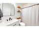 Well-lit bathroom featuring modern fixtures, a stylish mirror, floating shelves, and a shower with a patterned curtain at 217 Saint Andrews Ave, Edinburgh, IN 46124
