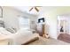 Bright bedroom features a ceiling fan, a dresser with a TV, and a comfortable bed with a textured comforter at 217 Saint Andrews Ave, Edinburgh, IN 46124