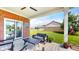 Relaxing covered patio featuring a ceiling fan, brick siding, cozy seating, and a view of the backyard at 217 Saint Andrews Ave, Edinburgh, IN 46124