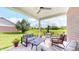 Inviting covered patio with comfortable seating, ceiling fan, and scenic golf course view at 217 Saint Andrews Ave, Edinburgh, IN 46124