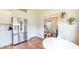 Bright kitchen with stainless steel refrigerator and hardwood floors open to dining area at 217 Saint Andrews Ave, Edinburgh, IN 46124