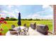 Outdoor patio features a table, umbrella, chairs, and golf course views at 217 Saint Andrews Ave, Edinburgh, IN 46124