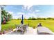 Relaxing outdoor patio with a table, chairs, grill and lovely views of the green golf course at 217 Saint Andrews Ave, Edinburgh, IN 46124