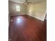 Spacious living room featuring gleaming hardwood floors and a bright window, perfect for relaxing at 2180 N Irwin St, Indianapolis, IN 46219