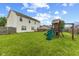 Expansive backyard featuring a well-maintained lawn, wooden deck, and a fun-filled playset at 2580 Bluewood Way, Plainfield, IN 46168