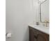 Elegant half-bathroom featuring a modern vanity with gold faucet and a sleek, black-framed mirror at 2580 Bluewood Way, Plainfield, IN 46168