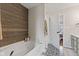 The bathroom includes a soaking tub with wood accent wall and modern fixtures at 2580 Bluewood Way, Plainfield, IN 46168