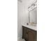 Bathroom featuring a wooden vanity with gold fixtures, a large mirror, and modern lighting at 2580 Bluewood Way, Plainfield, IN 46168