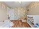 Bright bedroom featuring hardwood floors, floral wallpaper, and a charming toy swing at 2580 Bluewood Way, Plainfield, IN 46168