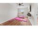 Neutral bedroom with hardwood floors, a ceiling fan, and fitness equipment at 2580 Bluewood Way, Plainfield, IN 46168
