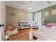 Cozy bedroom with hardwood floors, a swing, a chair, and a comfy bed at 2580 Bluewood Way, Plainfield, IN 46168