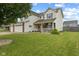 Charming home featuring a welcoming front porch, manicured lawn, and tasteful landscaping at 2580 Bluewood Way, Plainfield, IN 46168