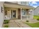 Inviting front porch featuring a cozy bench, decorative plants, and a welcoming entrance at 2580 Bluewood Way, Plainfield, IN 46168