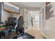 Functional home office area with a gaming chair and a clear view of the staircase through glass doors at 2580 Bluewood Way, Plainfield, IN 46168