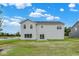 The backyard features a gray two-story house with a sliding glass door leading to a patio at 2733 Bo W St, Plainfield, IN 46168