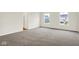 This airy bedroom boasts neutral walls, plush carpet, and bright windows with neighborhood views at 2733 Bo W St, Plainfield, IN 46168
