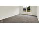 An empty bedroom features neutral walls, carpeted floors and a large window letting in natural light at 2733 Bo W St, Plainfield, IN 46168
