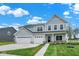 Charming two-story home boasts a three-car garage, well-manicured lawn, and inviting curb appeal at 2733 Bo W St, Plainfield, IN 46168