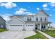 Charming two-story home boasts a three-car garage, well-manicured lawn, and inviting curb appeal at 2733 Bo W St, Plainfield, IN 46168