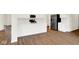Bright kitchen features white cabinets, stainless steel appliances, and wood-look flooring at 2733 Bo W St, Plainfield, IN 46168