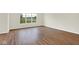 Bright living room boasts durable wood-look flooring and large windows, seamlessly connecting the indoor and outdoor spaces at 2733 Bo W St, Plainfield, IN 46168