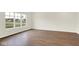 Bright living room boasts durable wood-look flooring and large windows, seamlessly connecting the indoor and outdoor spaces at 2733 Bo W St, Plainfield, IN 46168