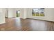Bright living room boasts durable wood-look flooring and large windows, seamlessly connecting the indoor and outdoor spaces at 2733 Bo W St, Plainfield, IN 46168
