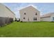 Backyard with large grassy area and the back of the house at 2834 Wolfgang Dr, Indianapolis, IN 46239