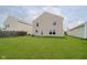 Backyard with large grassy area and back exterior of the house at 2834 Wolfgang Dr, Indianapolis, IN 46239
