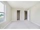 Spacious bedroom boasts soft carpeting, neutral paint, and closet and window access at 2834 Wolfgang Dr, Indianapolis, IN 46239