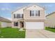 Charming two-story home with a well-maintained lawn and attached two car garage at 2834 Wolfgang Dr, Indianapolis, IN 46239