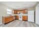 Functional kitchen featuring wood cabinetry, stainless steel appliances, and modern flooring at 2834 Wolfgang Dr, Indianapolis, IN 46239