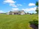 Spacious lawn with rear view of the house, patio, and beautiful yard at 3150 Green Brook Ln, Frankfort, IN 46041