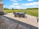 Beautiful backyard patio with table and chairs overlooking the expansive lawn at 3150 Green Brook Ln, Frankfort, IN 46041
