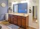 Well-lit bathroom with double sinks, wood cabinets, and neutral-toned decor at 3150 Green Brook Ln, Frankfort, IN 46041