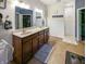 Bathroom featuring a double vanity and a walk-in shower with custom tile work at 3150 Green Brook Ln, Frankfort, IN 46041