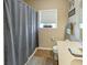 Functional bathroom with a toilet, bathtub and shower featuring a gray curtain, offering a clean and practical space at 3150 Green Brook Ln, Frankfort, IN 46041