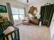 Cozy bedroom featuring a crib, chair, and dresser bathed in natural light from a window, creating a warm and inviting space at 3150 Green Brook Ln, Frankfort, IN 46041