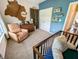 Charming bedroom with a crib, recliner, and dresser, complemented by blue walls and cozy decor for a relaxing ambiance at 3150 Green Brook Ln, Frankfort, IN 46041