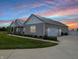 This home boasts a large garage and driveway, lush landscaping, and a serene rural setting at 3150 Green Brook Ln, Frankfort, IN 46041
