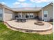 Spacious outdoor patio with stone pavers, firepit, seating and scenic backyard at 3150 Green Brook Ln, Frankfort, IN 46041