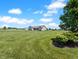 Beautifully maintained lawn with view of house, detached garage, and open sky at 3150 Green Brook Ln, Frankfort, IN 46041