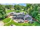 Aerial showcasing backyard with fire pit, patio, hot tub, and lush green lawn, framed by mature trees at 3528 E 116Th St, Carmel, IN 46033
