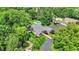 Aerial view of a stone home with in-ground pool and mature landscape at 3528 E 116Th St, Carmel, IN 46033