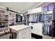 Spacious walk-in closet features custom shelving, island, washer, dryer, and hanging racks for optimal organization at 3528 E 116Th St, Carmel, IN 46033