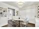 Cozy dining area with modern chandelier, a round table, and view into a kitchen area at 3528 E 116Th St, Carmel, IN 46033