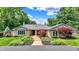 Charming single-story home with stone facade, landscaped front yard and mature trees at 3528 E 116Th St, Carmel, IN 46033